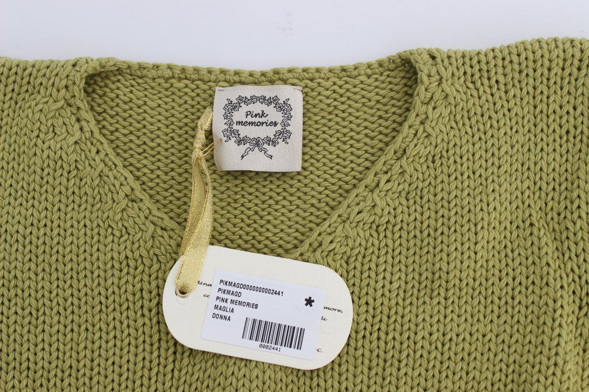 Green knitted sweater on hanger with tag