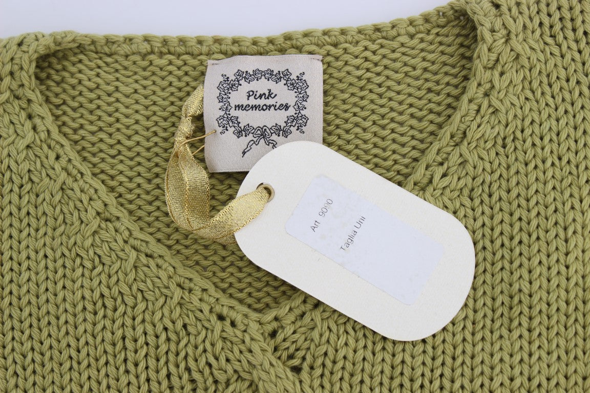 Green knitted sweater with tag attached to neckline