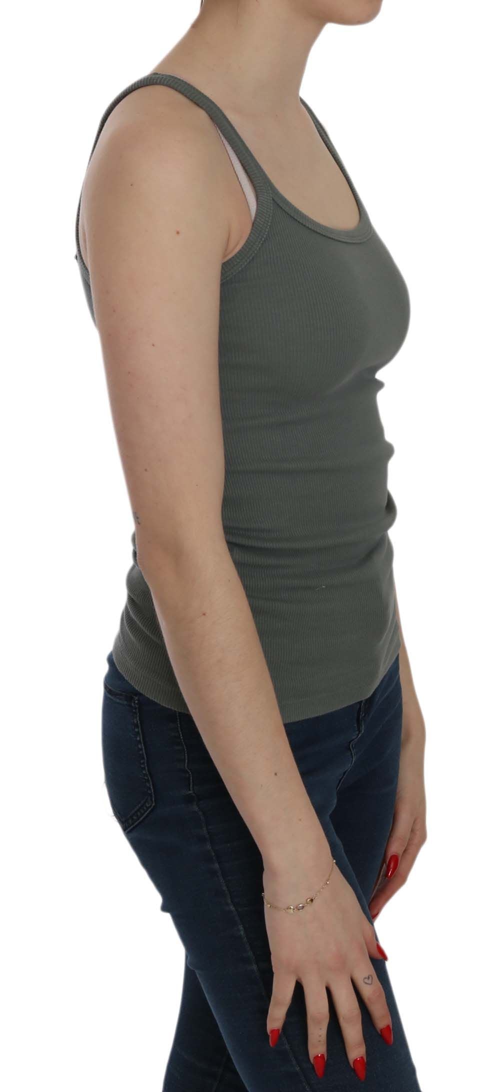 Woman wearing gray tank top and blue jeans