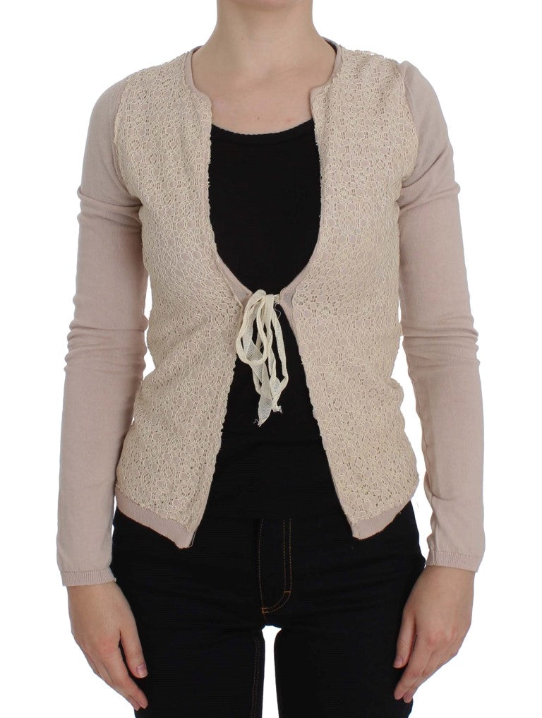Woman wearing a beige crochet vest over black shirt