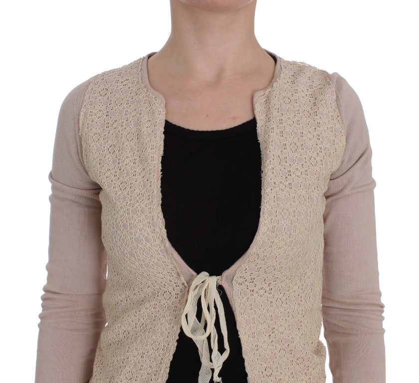 Woman's beige lace cardigan over black shirt