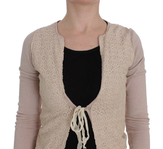 Woman's beige lace cardigan over black shirt