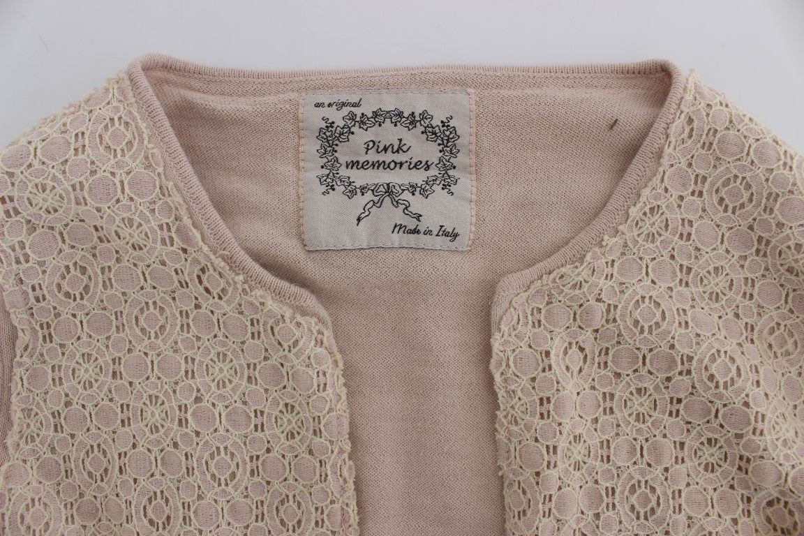Pink lace cardigan with a label on the inside