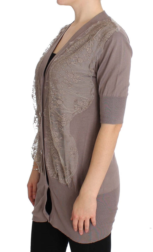 Woman wearing a long sleeve vest over a black top