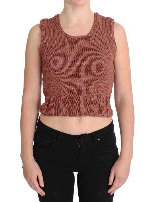 Woman wearing crocheted vest over black pants