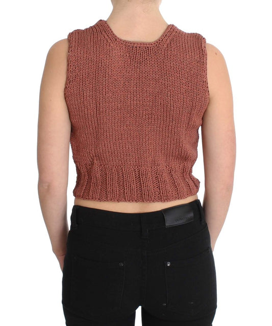 Woman wearing a red crocheted vest over black pants