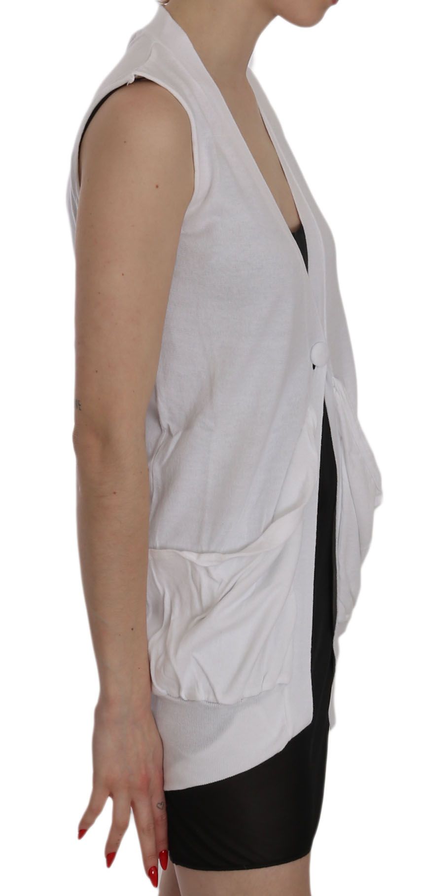 Woman wearing a white vest over black shorts