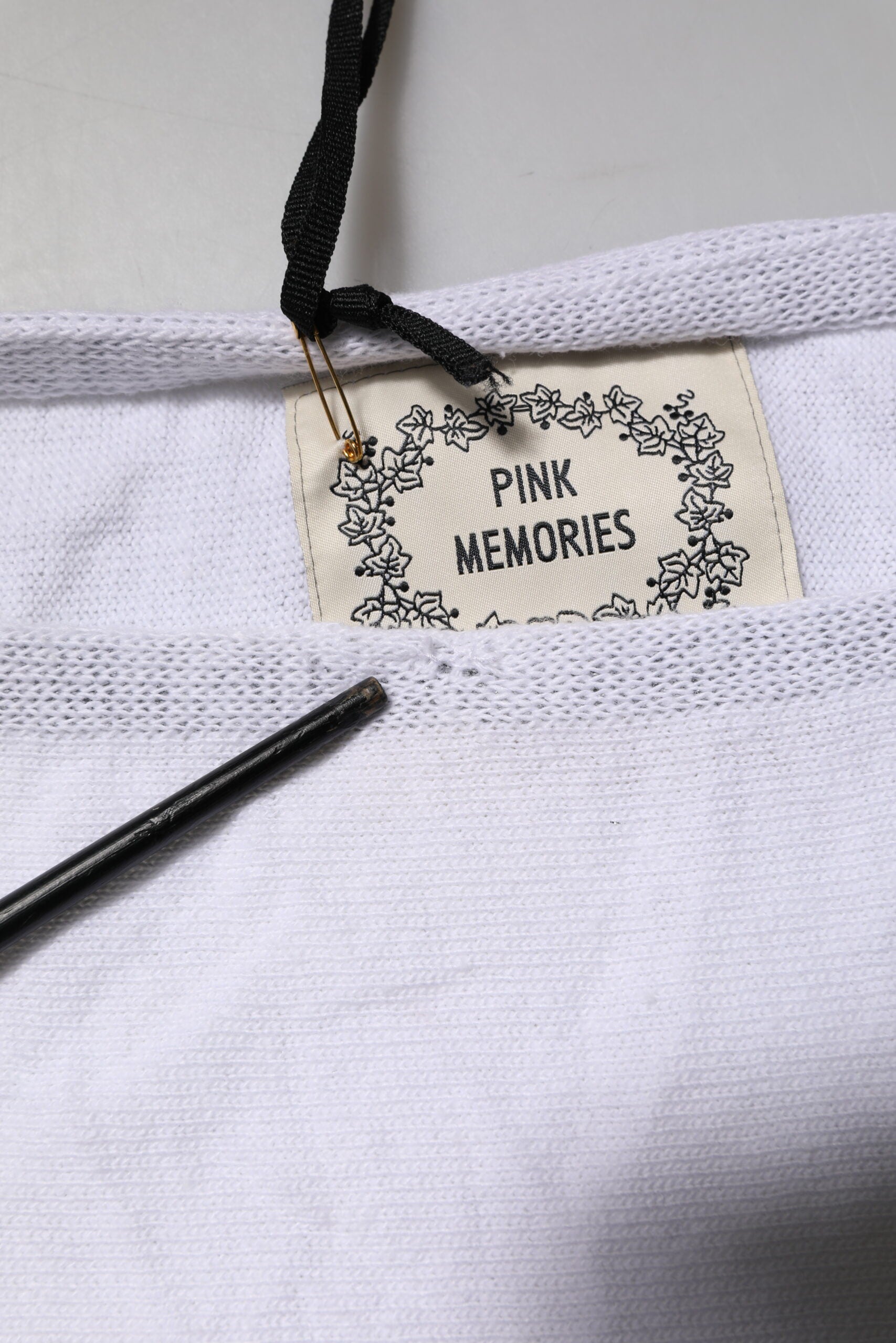 White t-shirt with black label reading "Pink Memories"