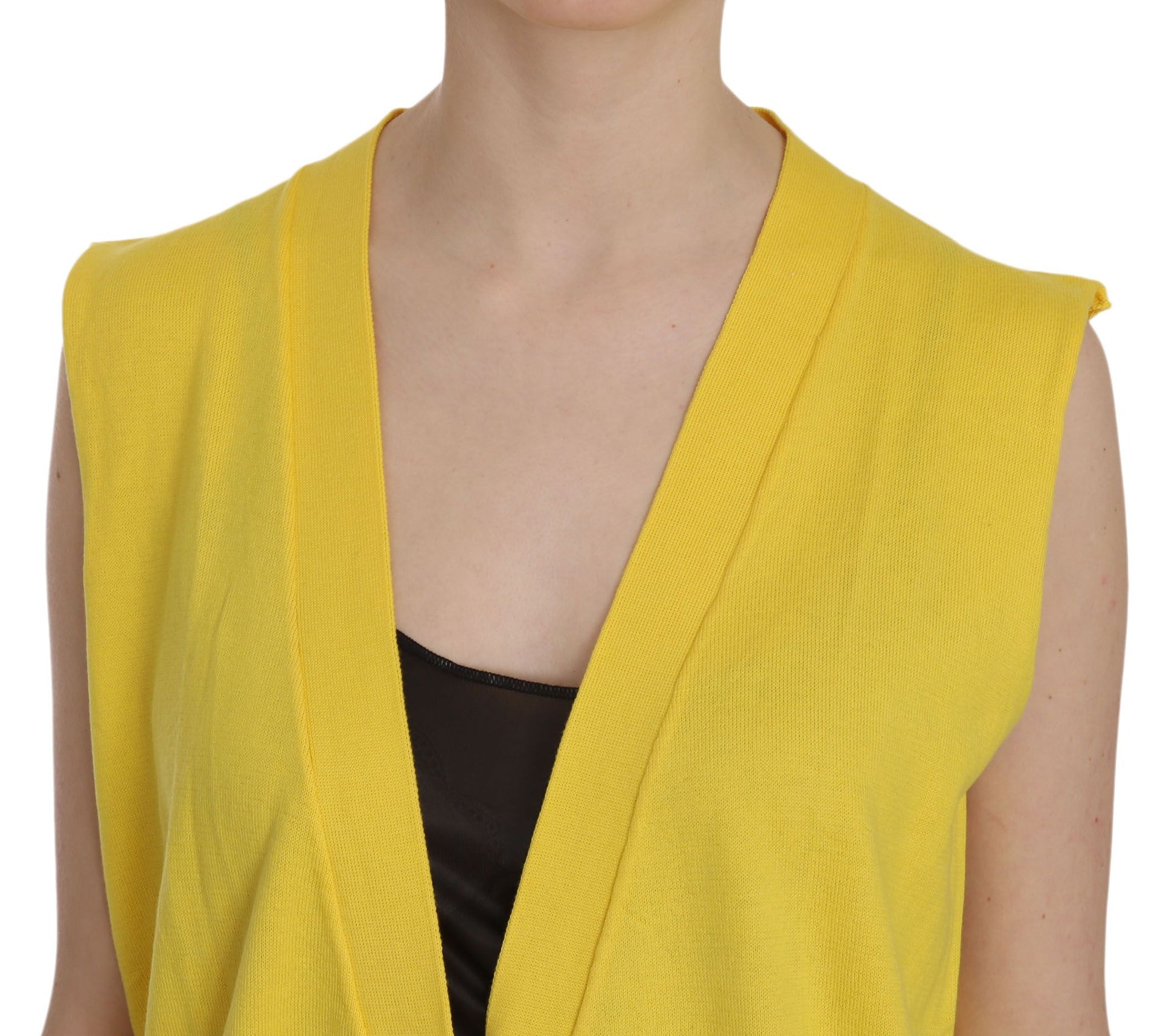 Yellow knitted vest on woman's shoulders