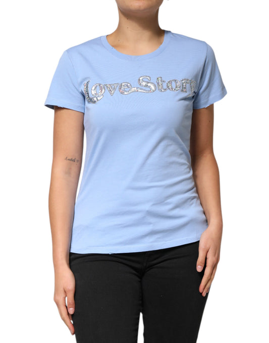 Woman wearing blue t-shirt with silver glittery letters