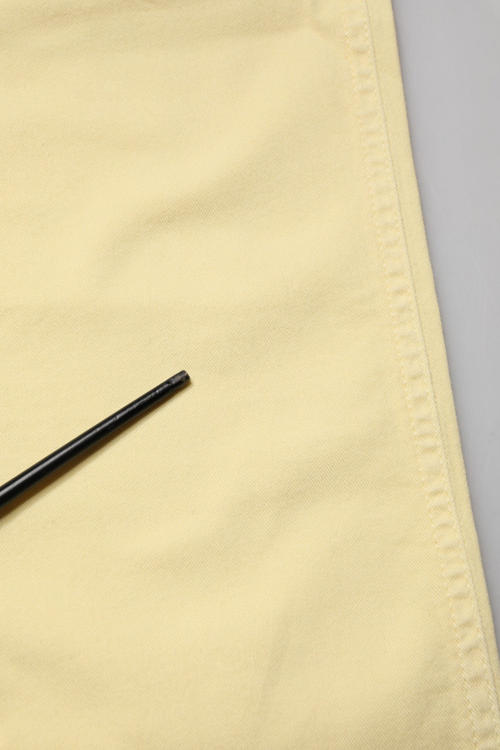 Yellow fabric with black pin
