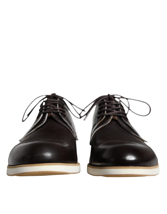 Pair of black lace-up dress shoes with white soles, featuring a polished leather finish