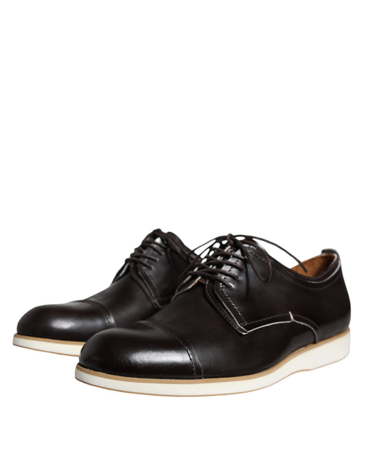 Pair of black leather lace-up dress shoes with white soles, designed for men's formal wear
