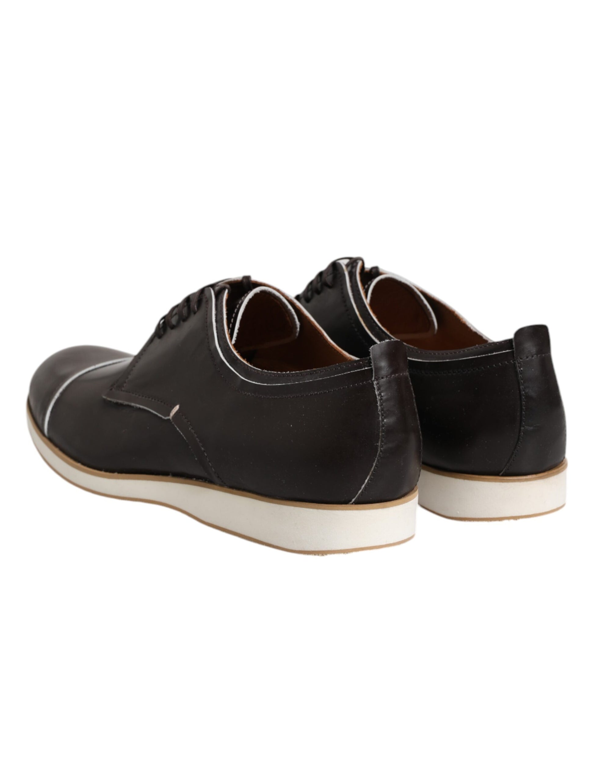 A pair of dark brown leather lace-up dress shoes with a white sole and black laces
