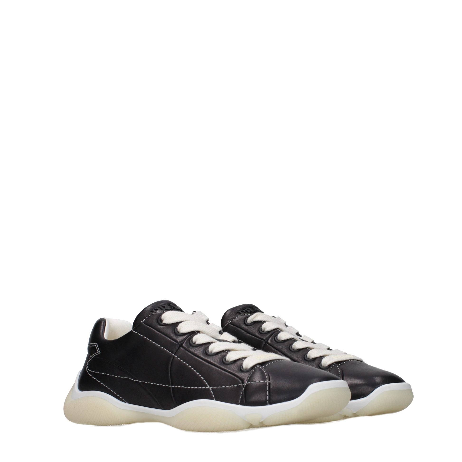 Pair of black leather sneakers with white laces and a rubber sole