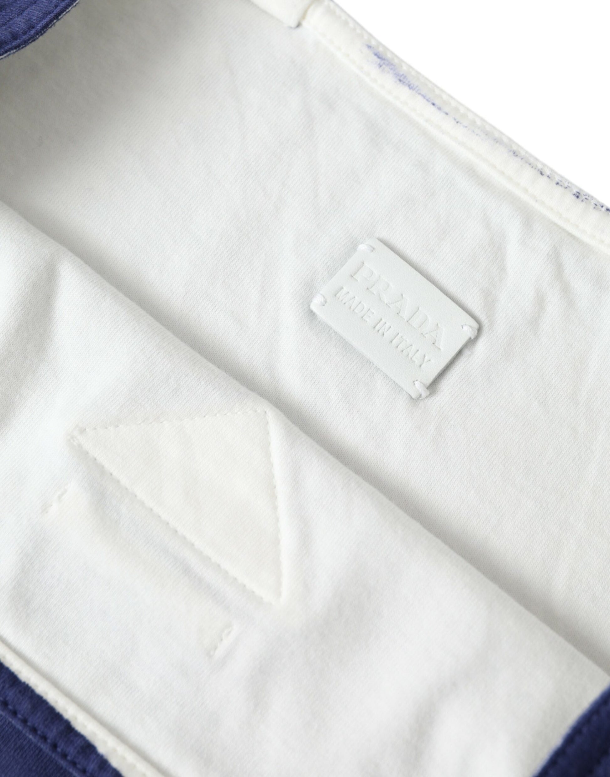 White cloth with blue trim and a label on the front