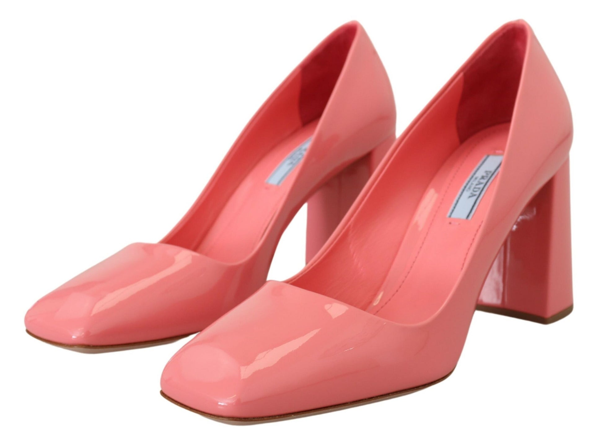 Pair of red high heel shoes with a label on the insole