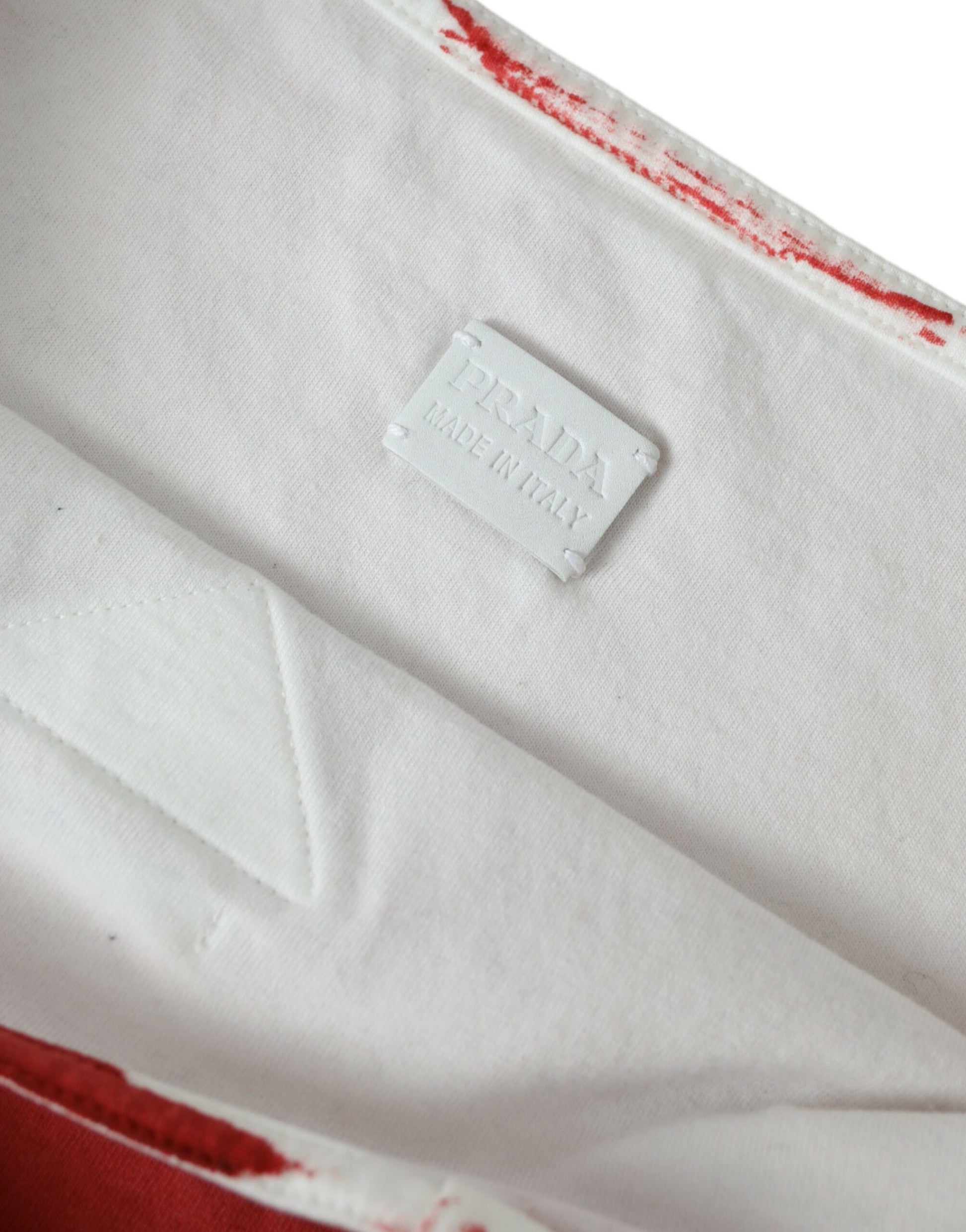 White shirt with red trim and a label on the inside collar
