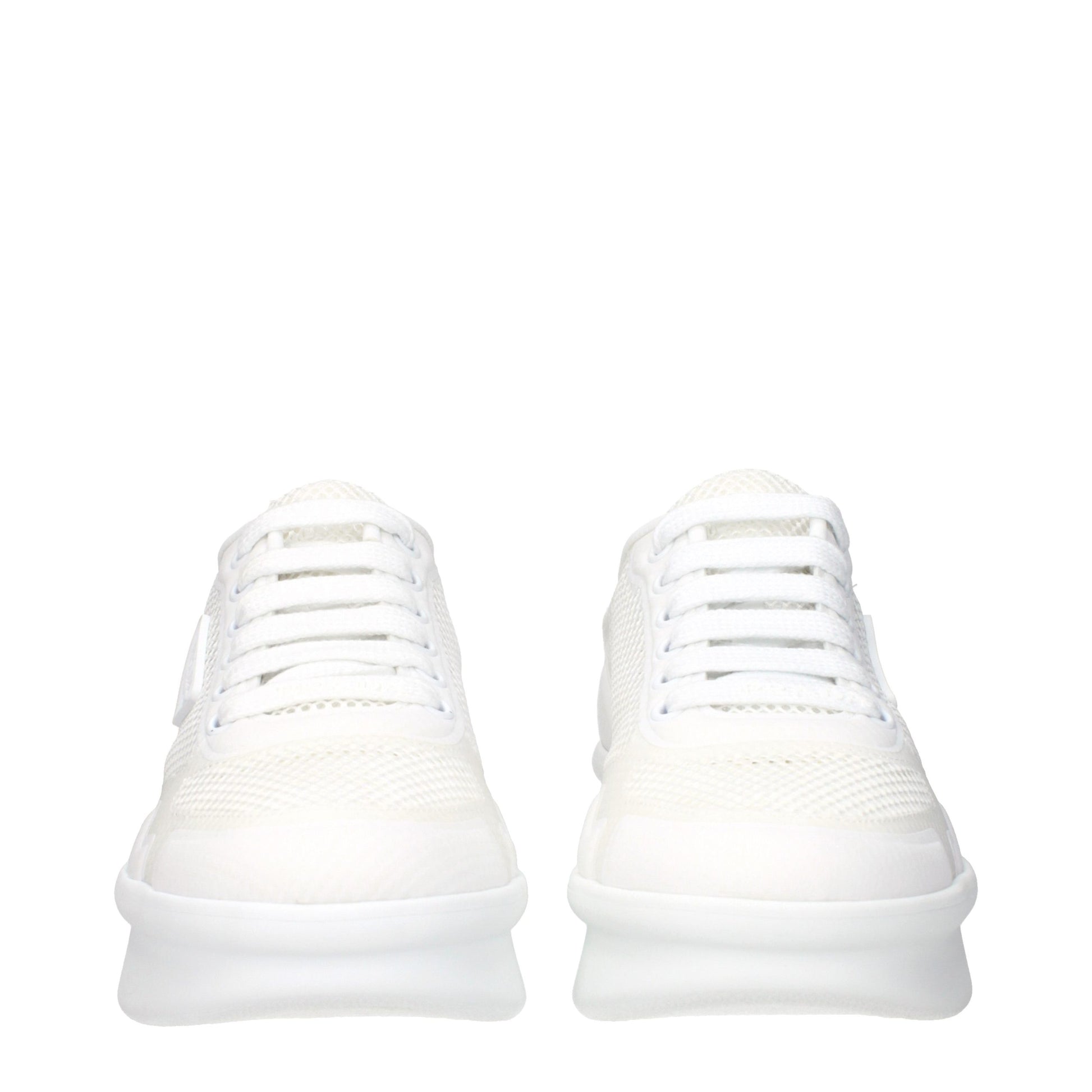 Pair of white athletic sneakers with fabric upper