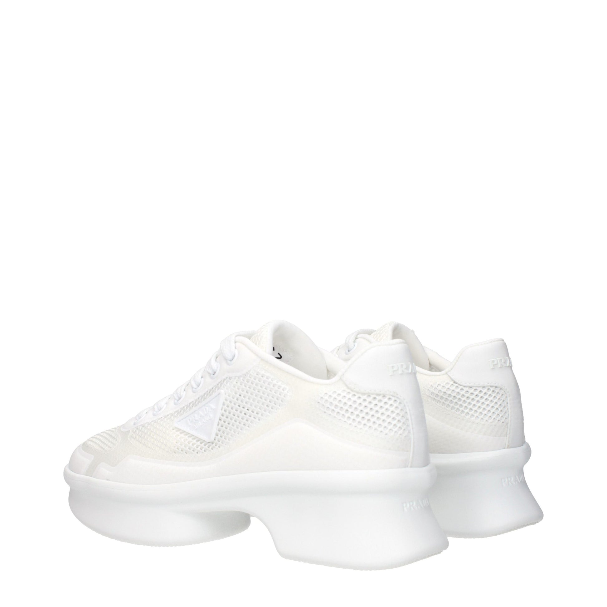 Pair of white athletic sneakers with fabric upper, lace closure, and flat sole