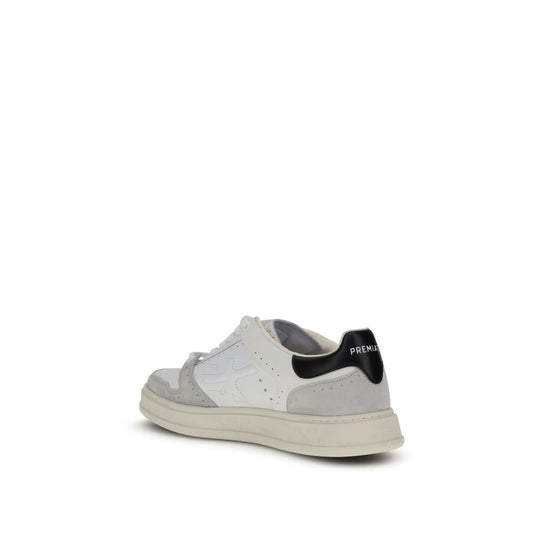 A pair of white calf leather sneakers with black laces and a low top design