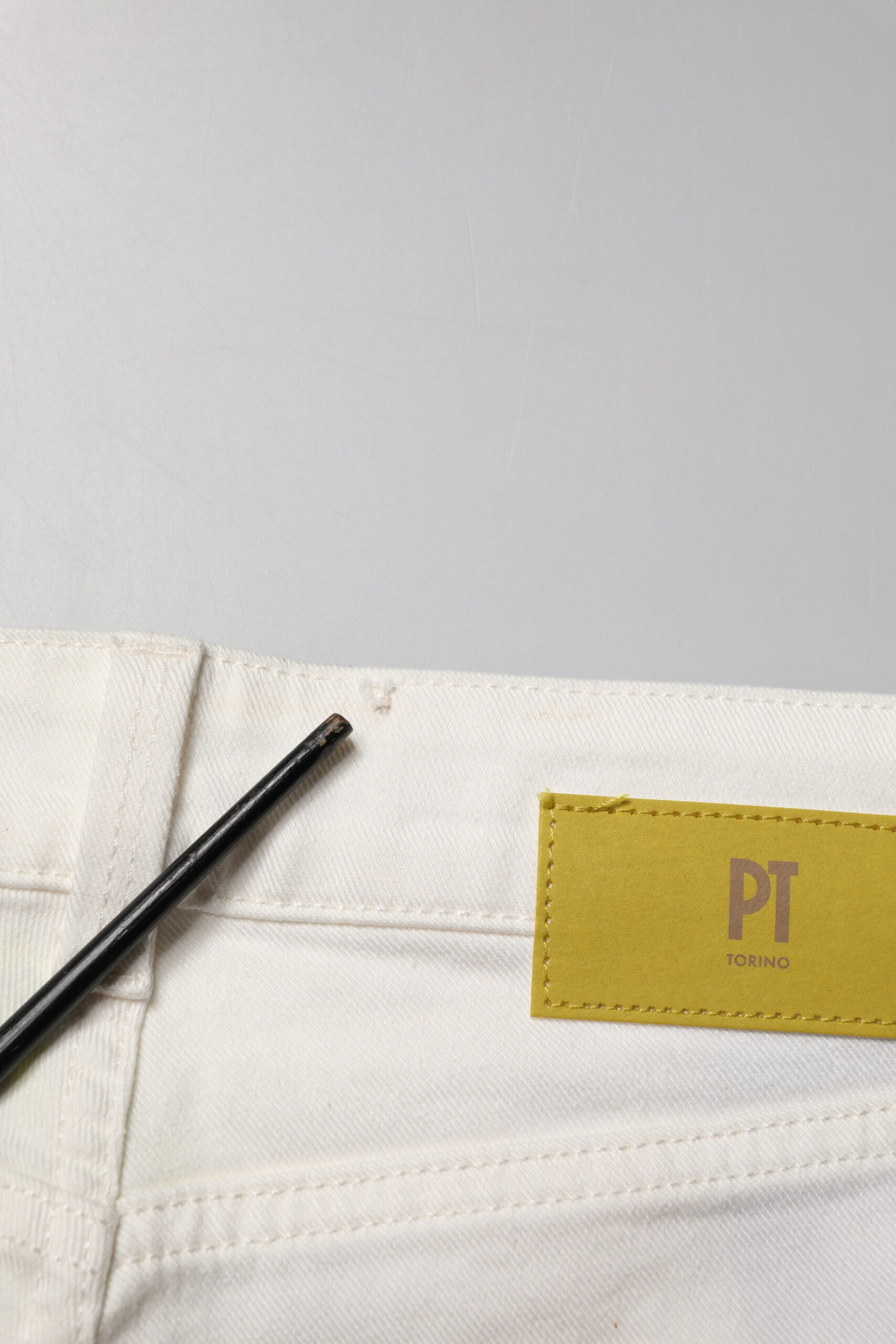 Pair of light colored jeans with a tag inside