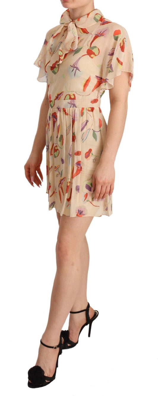 A beige dress with a floral pattern and an ascot collar, short sleeves, and a mini length