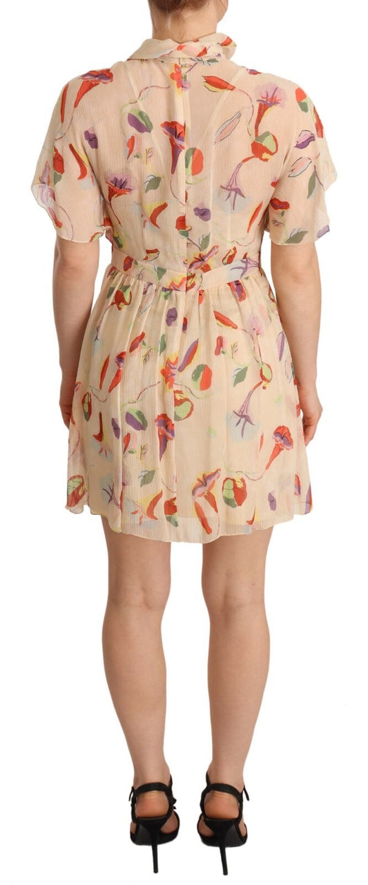 A beige dress with a floral pattern and an ascot collar, short sleeves, and a mini length