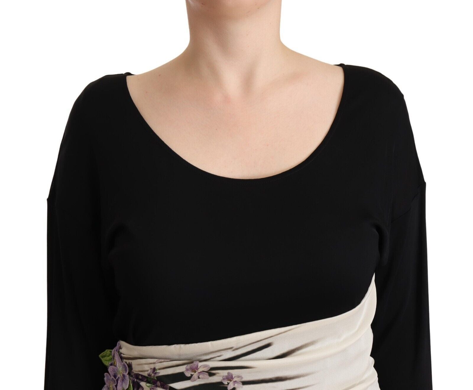 A black knee length dress with silver accents, featuring a sheath silhouette and a V-neckline