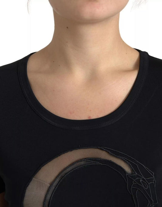 Woman wearing black shirt with embroidered design on chest
