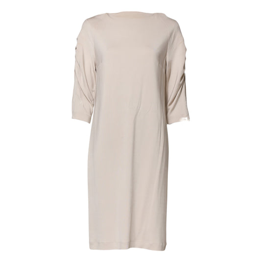 A knee-length dress in a light beige color, made of viscose material