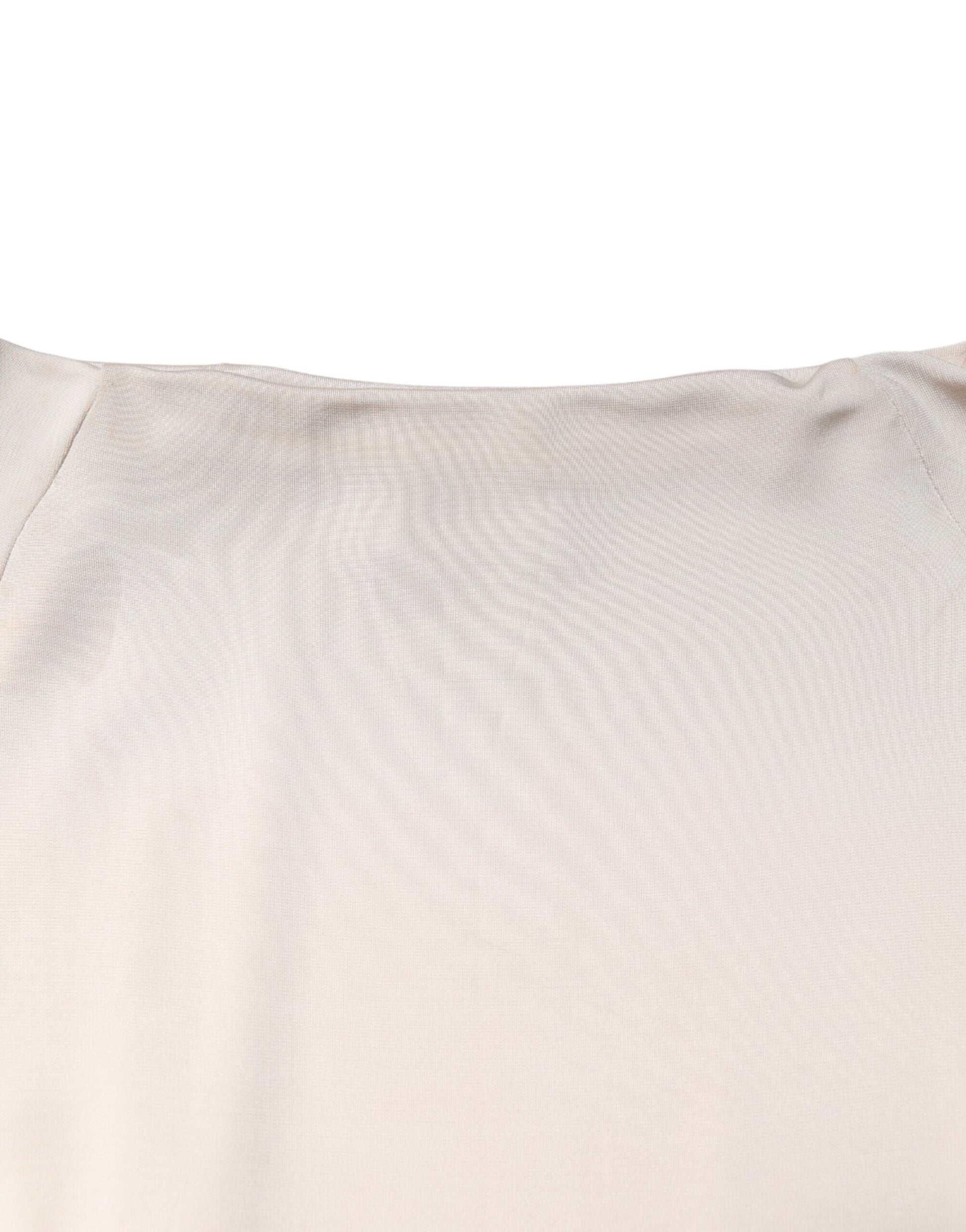 A knee length dress in ivory viscose fabric with a sheath silhouette