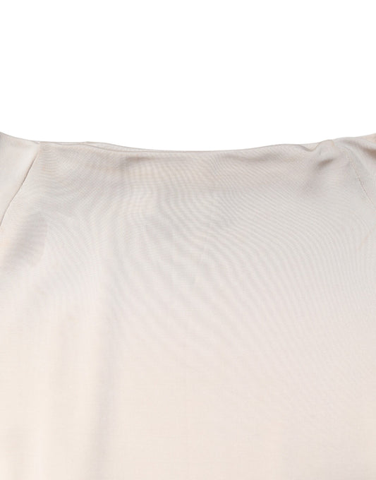 A knee length dress in ivory viscose fabric with a sheath silhouette