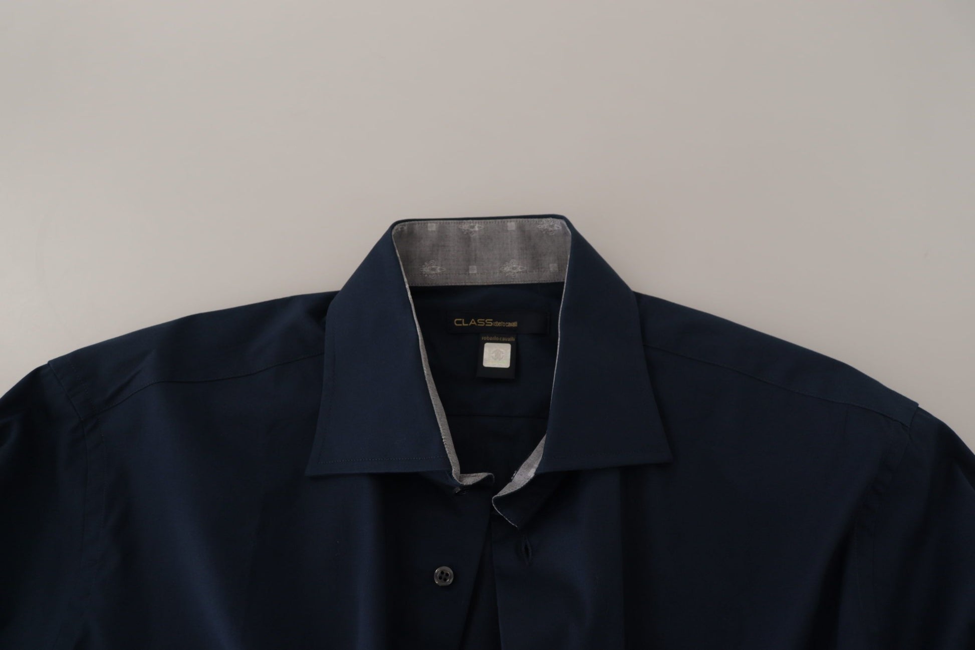 A navy blue dress shirt with a collar, long sleeves and buttoned front