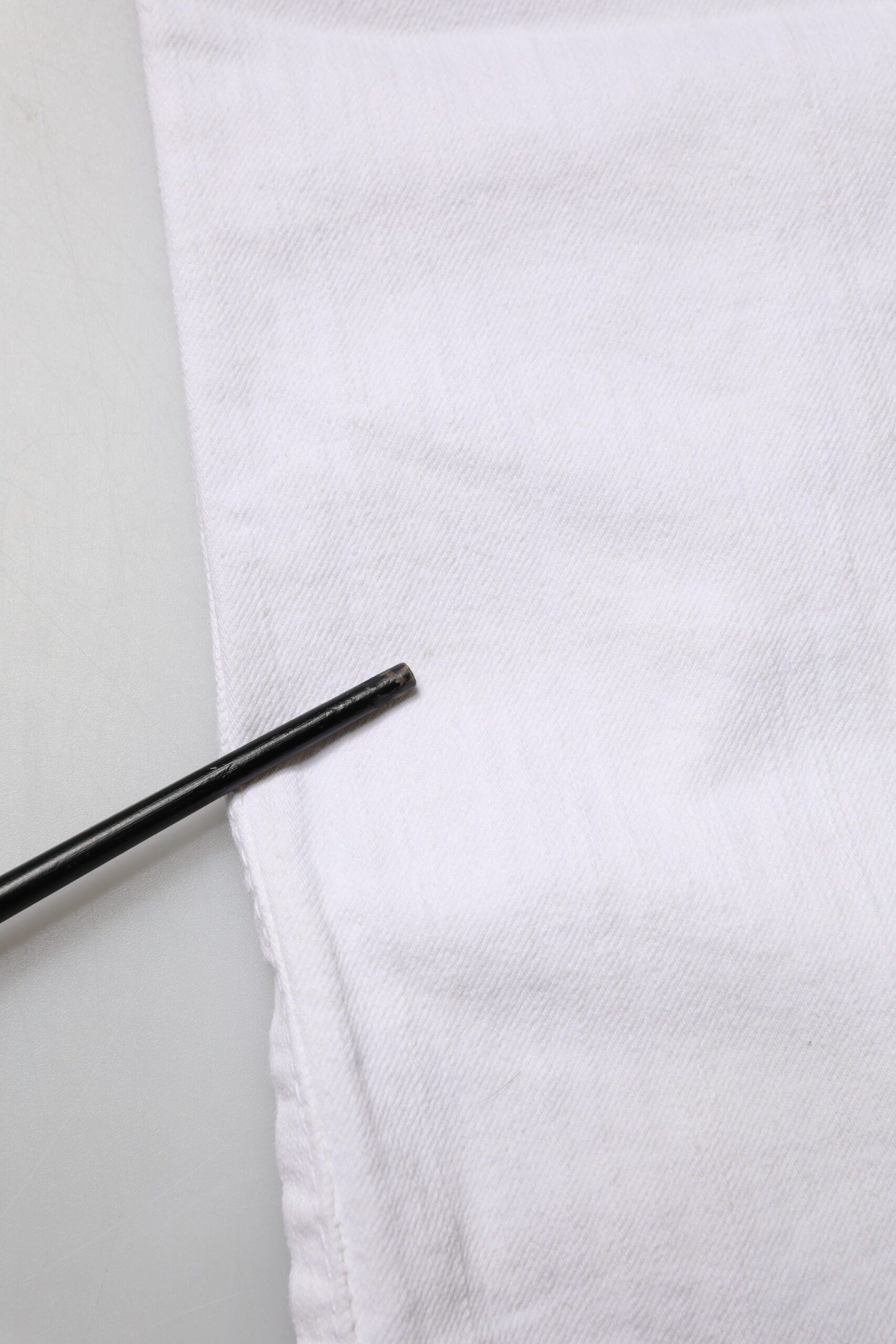 White cloth with black pin