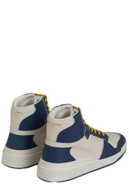Pair of blue and white sneakers with yellow laces