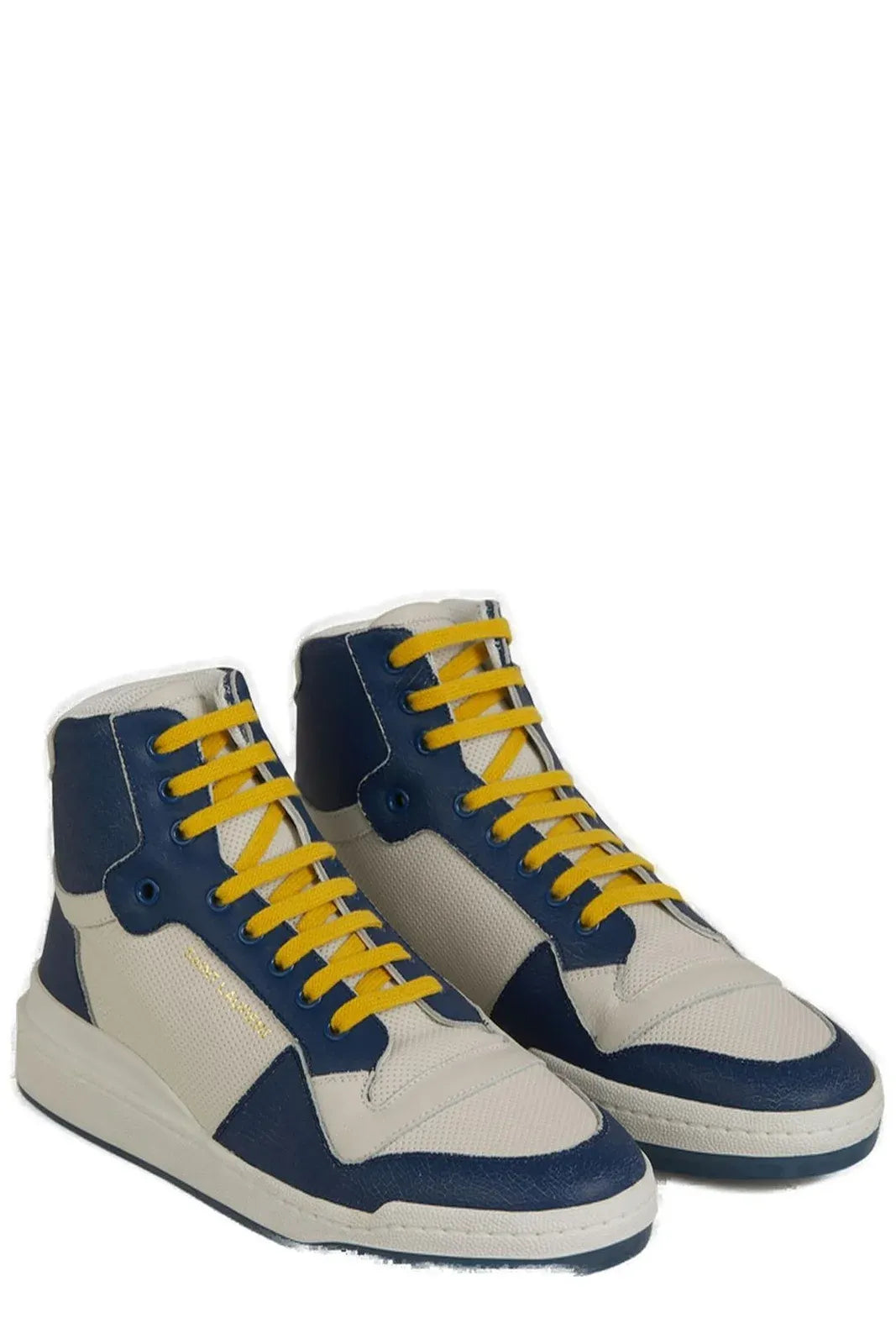 Pair of blue and white sneakers with yellow laces