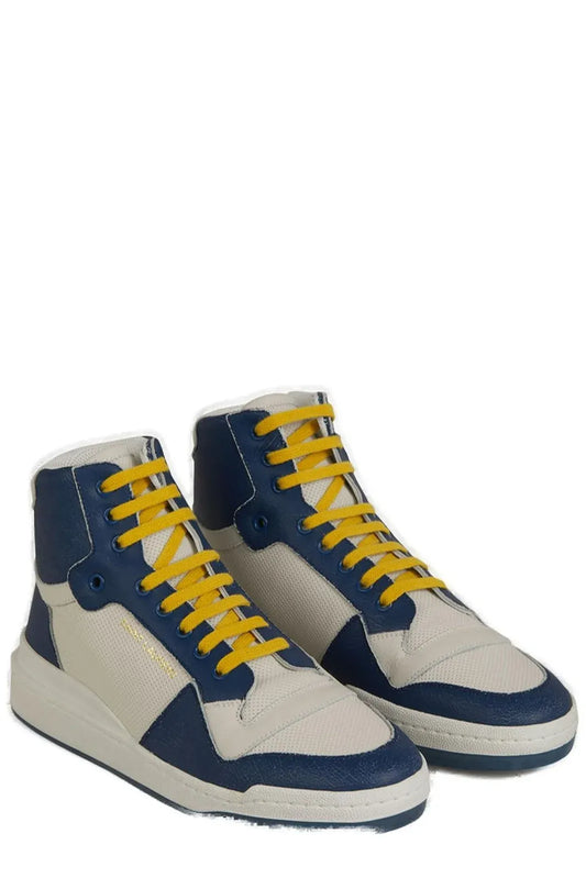 Pair of blue and white sneakers with yellow laces