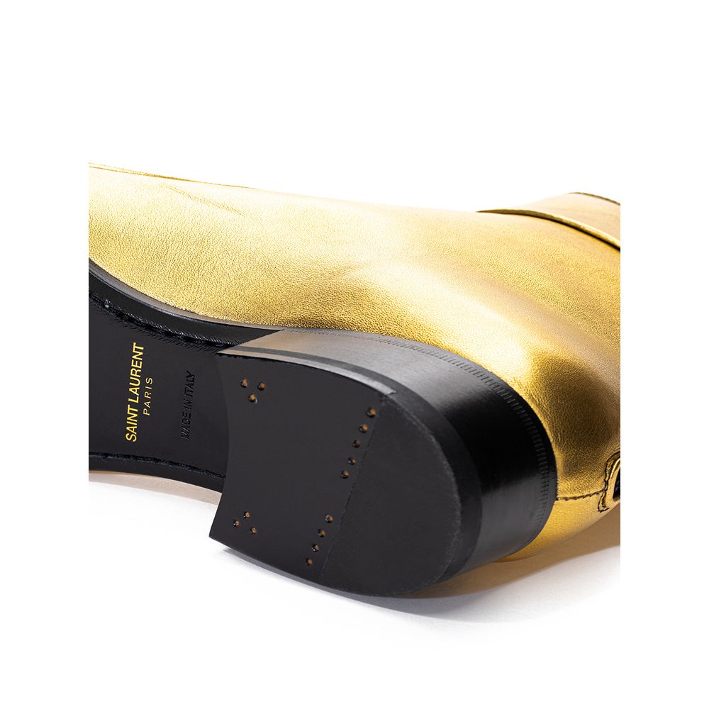 Black and gold boot with a strap