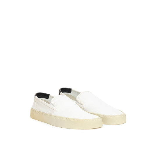 Pair of white slip on shoes with black soles and laces