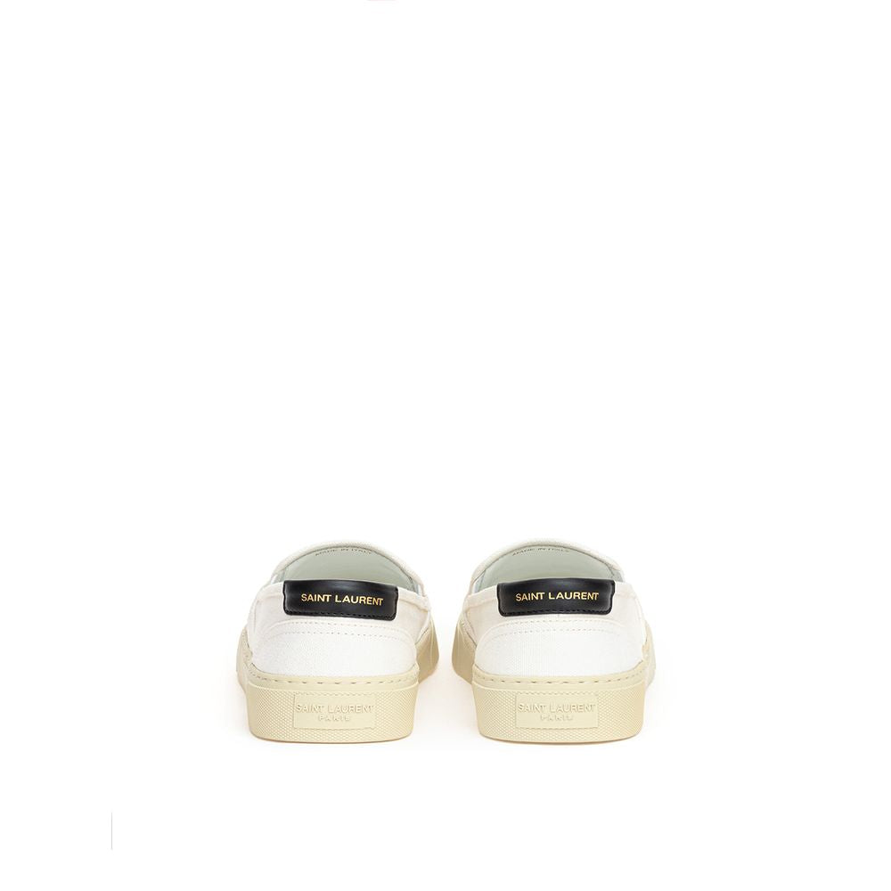 Pair of white sneakers with tan soles and laces