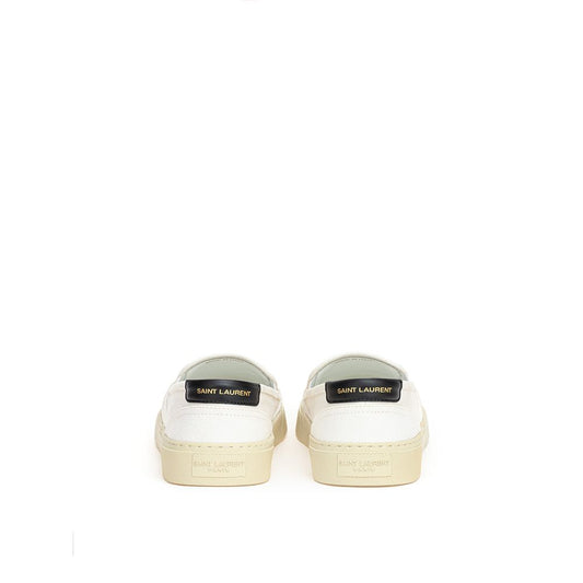 Pair of white sneakers with tan soles and laces