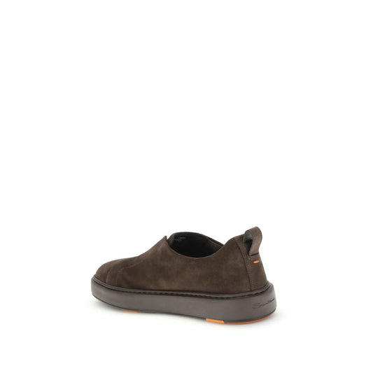 A pair of brown leather sneakers with orange laces and a low top design