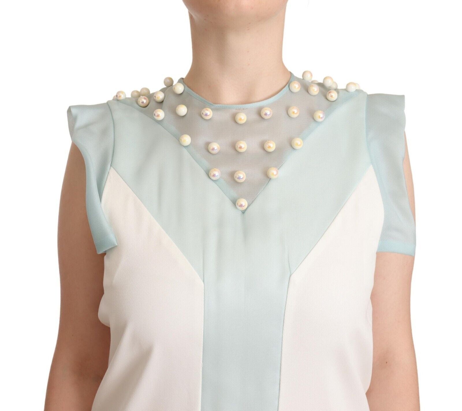 A sleeveless shift dress with a multicolored design and faux pearls
