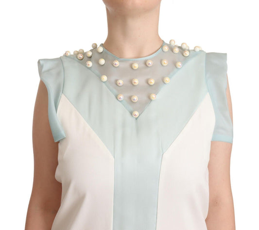 A sleeveless shift dress with a multicolored design and faux pearls