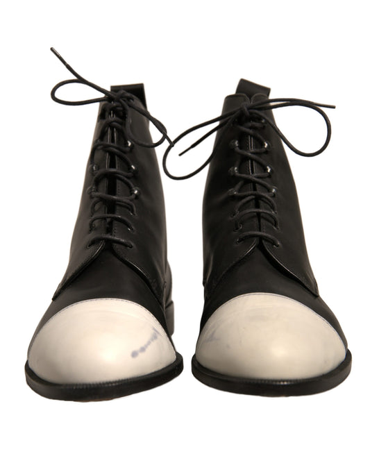 Pair of black boots with white soles