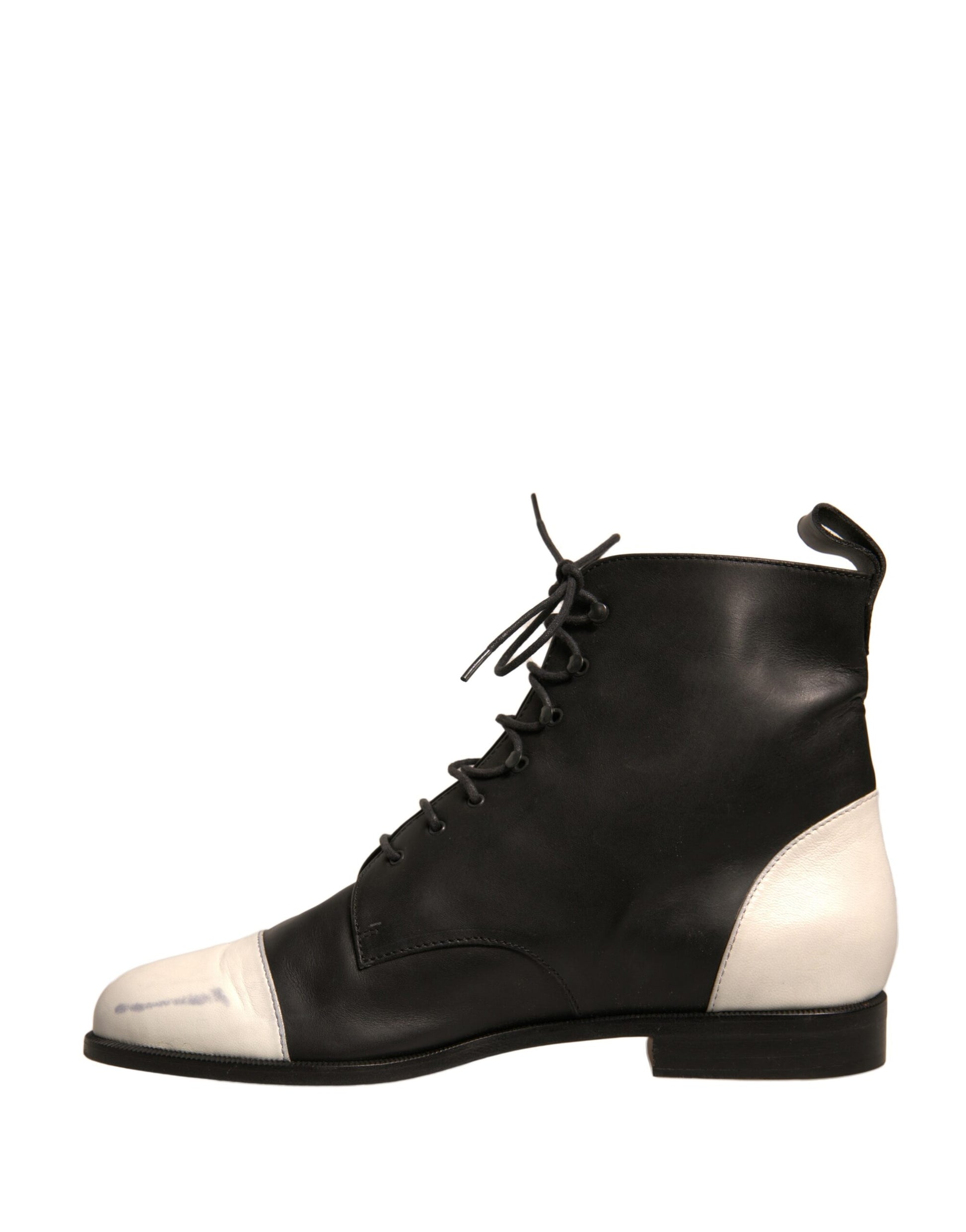 Black ankle boot with white laces and a small heel