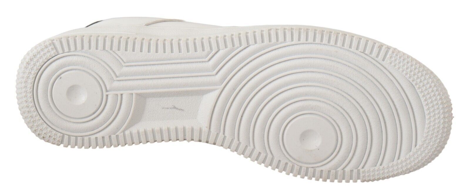 Pair of white sneakers with laces and soles