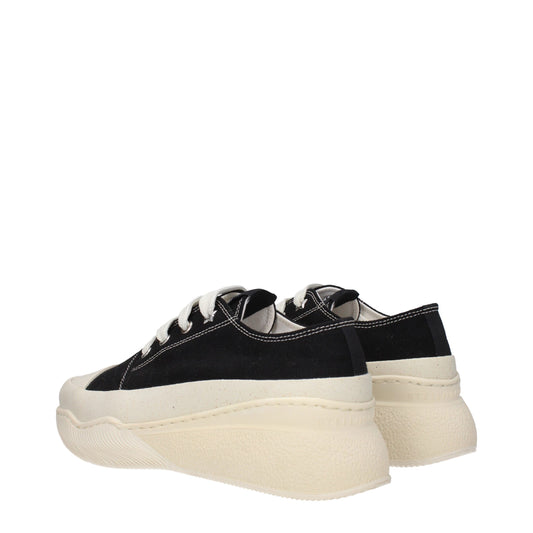 A pair of black chunky sneakers with white soles, designed by Stella McCartney