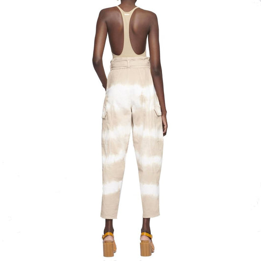 Woman wearing beige tie dye pants with a backless top
